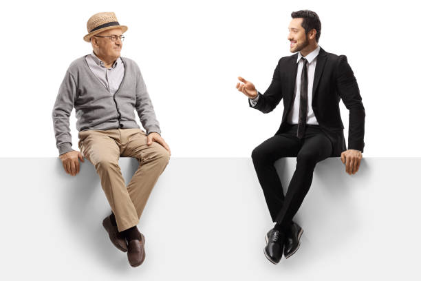 istock Elderly man and a businessman sitting on a panel and talking 1197836099
