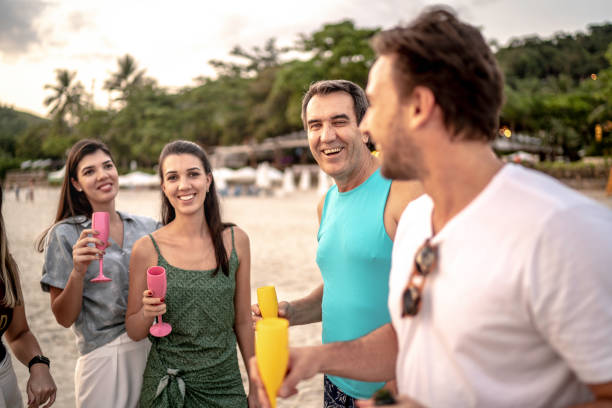 istock Group of friends celebrating at beach 1197837401
