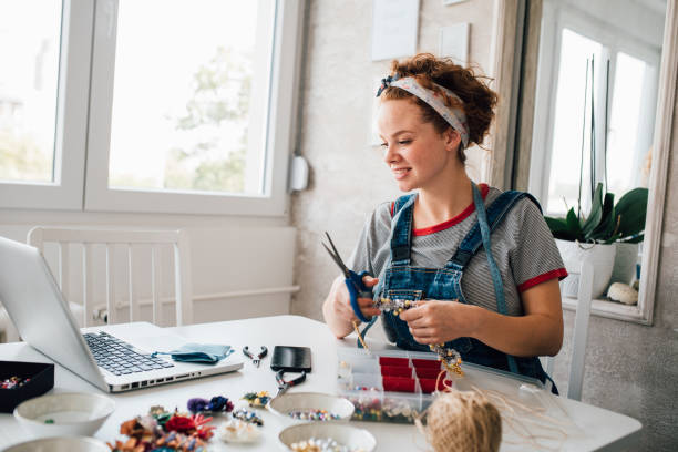 istock Young woman watching tutorials of how to make jewelry 1197837609