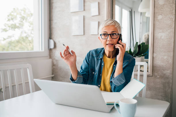istock Mature woman having a business talk while working from her home 1197837817