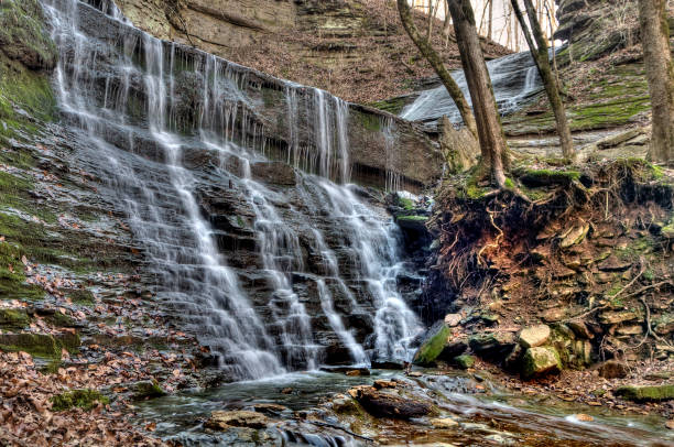 istock Waterfall flowing over aged and mossy grey rocks on a switchback 1197837841