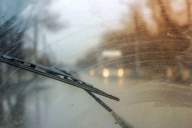 Windshield wipers from inside of car, season rain. the front and background are blurred with a bokeh effect