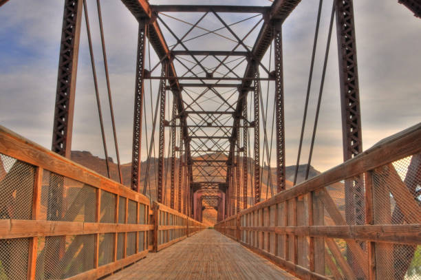 istock Perspective view a bridge and of its wooden deck walkway 1197838493