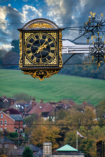 A 336 year old clock hangs over the streets and houses of Guildford High Street