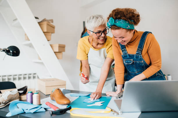 istock Mother and daughter designing leather shoes 1197838580