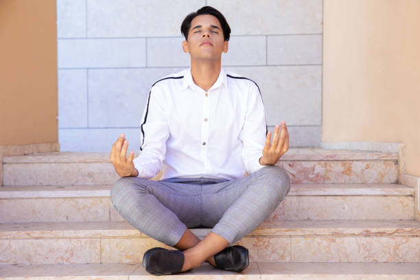 istock Tranquil man meditating on stairs 1197838601