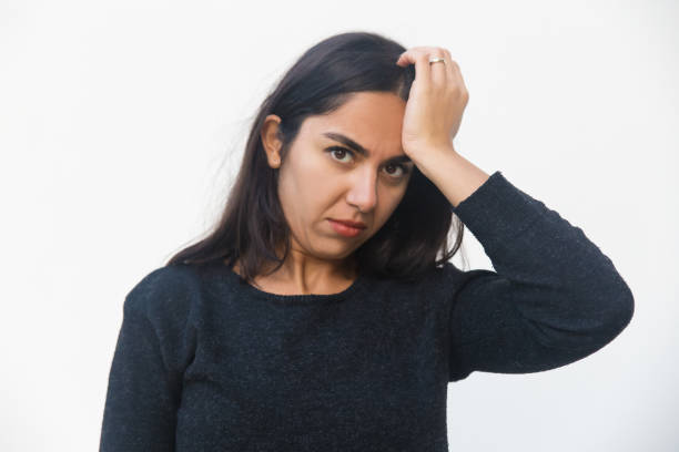 istock Puzzled serious woman touching head 1197838766
