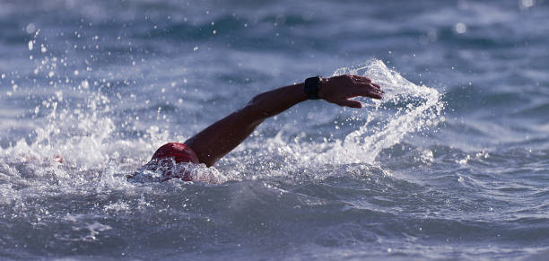 istock Man swimmer swimming crawl in blue sea 1197839661