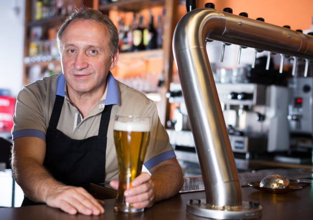 istock Barman is standing with golden beer 1197839970