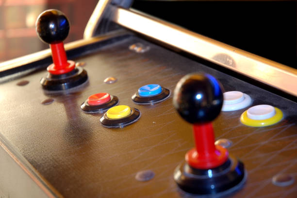 istock vintage arcade videogame - angle view of joystyck and button console 1197840770