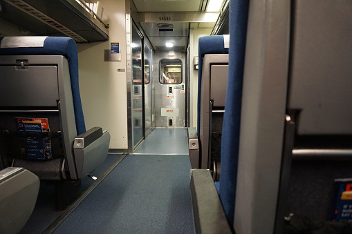Looking down the aisle of an empty Amtrak train car on the Hiawatha Service Line en route from Chicago to Milwaukee in late December.
