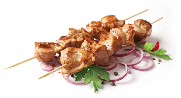 skewers of pork shish kebab isolated on white background, selective focus