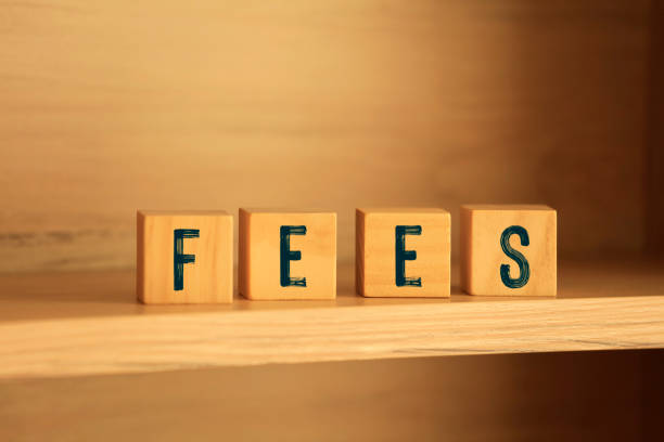 istock Fees. Close-Up Of Text On Wood Background 1197842060