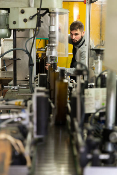 istock Man controlling olive oil bottling 1197842142