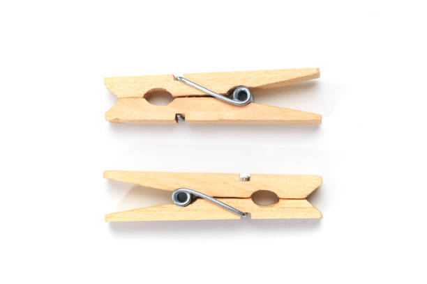 istock Brown wood clothes peg or clothespin on white background. 1197846546