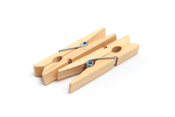 istock Brown wood clothes peg or clothespin on white background. 1197846594