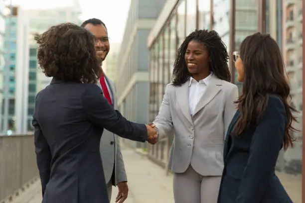 Photo of Successful company representatives greeting each other