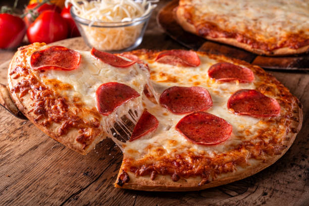 pepperoni and four cheese pizzas - stringy imagens e fotografias de stock