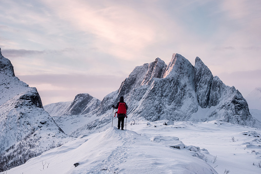 Traveler standing on top of Segla mountain in winter at Senja Island, Norway