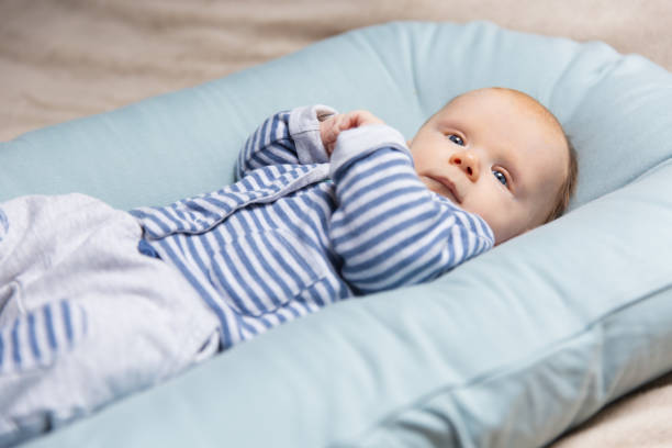 istock Serious cute red haired baby wearing blue and grey clothes 1197851727