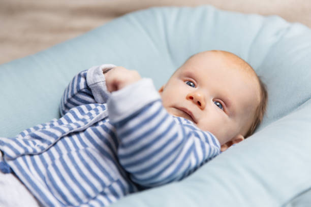 istock Surprised red haired baby in blue and grey clothes 1197852814