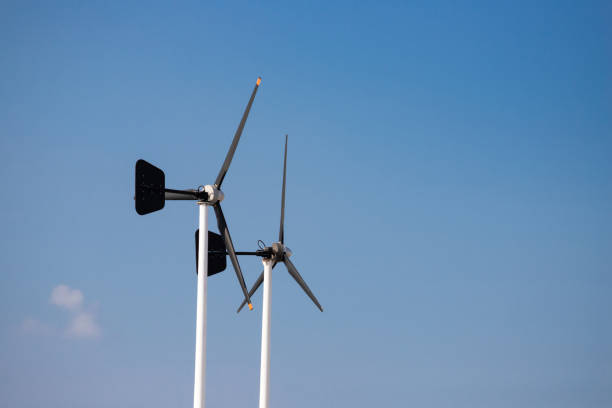 istock black wind turbine against blue sky background. selective energy. 1197853232