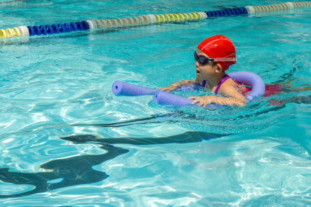 istock kid learn how to swim in swimming class 1197854549