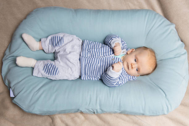 istock Pensive red haired baby wearing blue and grey clothes 1197855837