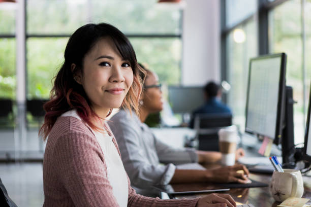 istock Confident business woman smiles for camera in co-working space 1197855961