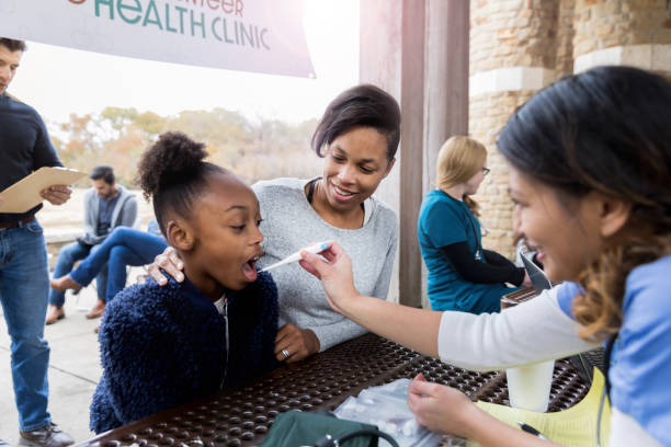 istock People wait in line as nurse takes child's temperature 1197856241