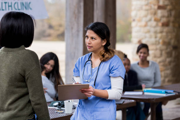 istock While other patients wait, nurse asks unrecognizable woman questions 1197856282