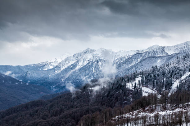 istock High mountain peaks covered with snow on a winter cloudy day 1197856428