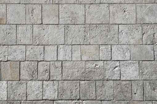 Grey modern coble stone background. Close up top view on monotone gray brick stone. Sidewalk or pavement. Top view, copy space