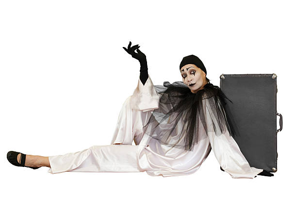 sitting pierrot with suitcase isolated stock photo