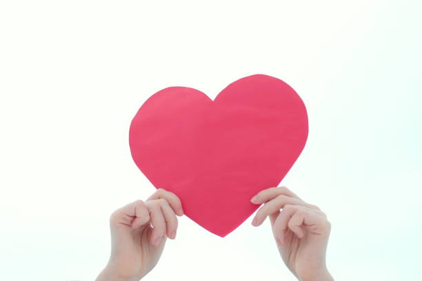 istock Hand holds red heart on a white background. 1197863623