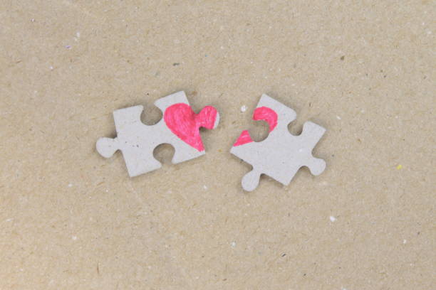 istock Puzzle with a heart on the brown background. 1197864837