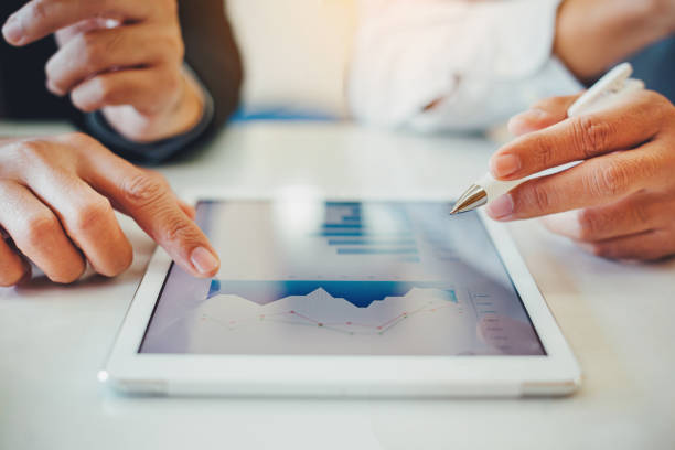istock businessman working on project for analyzing company financial report balance statement with documents graphics at modern office space. Concept picture of business,economy, market,money and tax. 1197865040