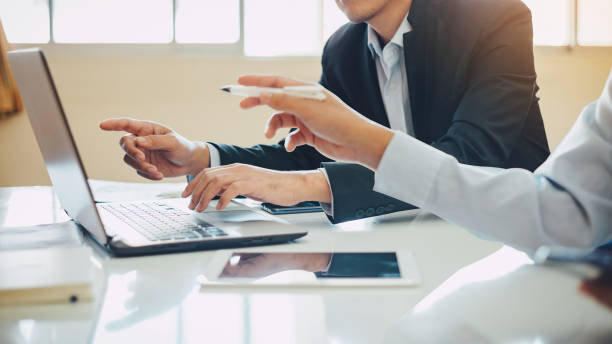 istock businessman working on project for analyzing company financial report balance statement with documents graphics at modern office space. Concept picture of business,economy, market,money and tax. 1197865064