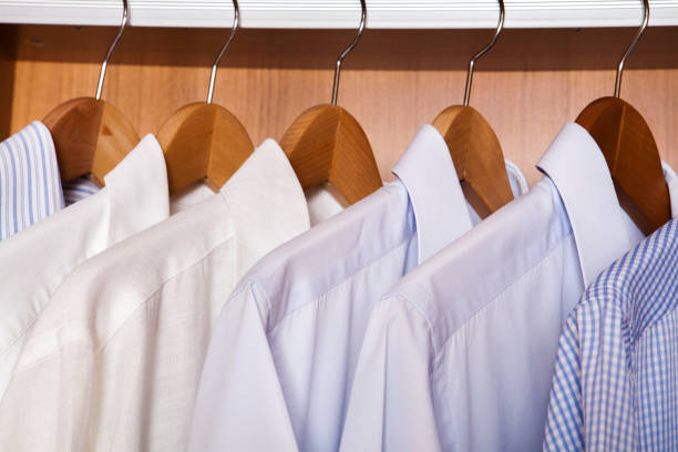 istock Colored shirts on wooden background. 1197865127