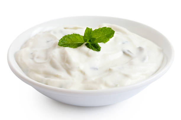 istock Tzatziki in white ceramic bowl isolated on white. Mint leaf garnish. 1197866750