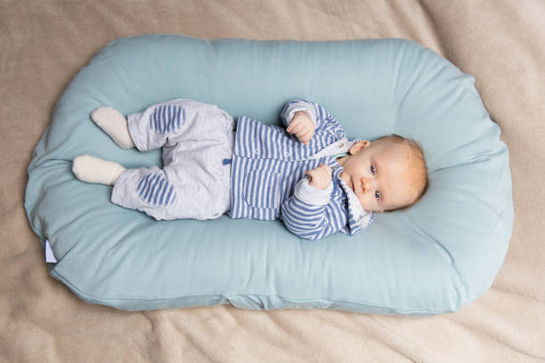 istock Calm red haired baby wearing blue and grey clothes 1197868634
