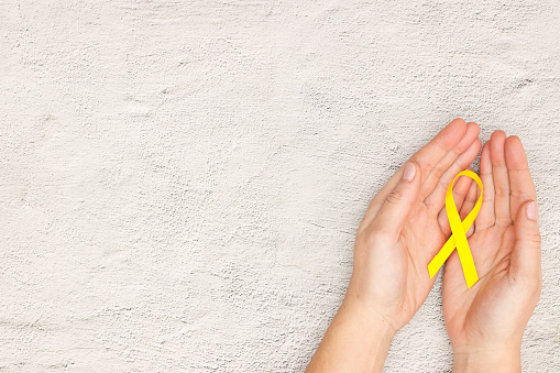 Yellow ribbon for world childhood cancer day - Support for the fight against cancer