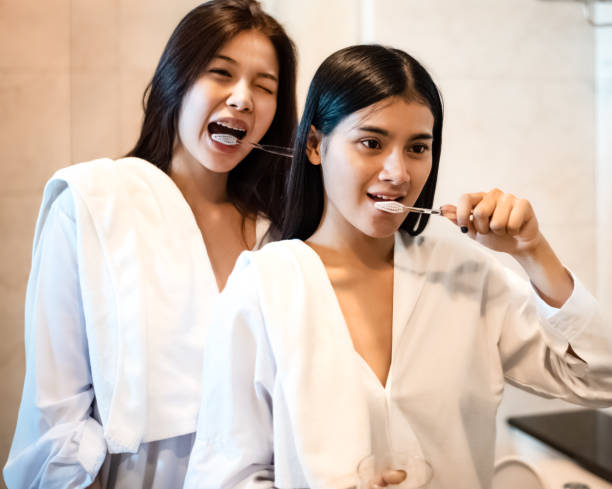 istock Two beautiful women brushing teeth in bathroom,doing activity together,gender expression,best relationship,good friendship, 1197870648