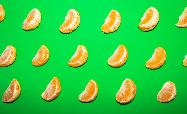 istock Tangerine pattern on a green background, top view 1197872144