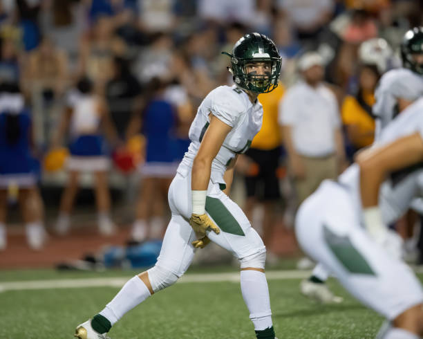 young football player in action during a game - football player american football sports team teamwork imagens e fotografias de stock