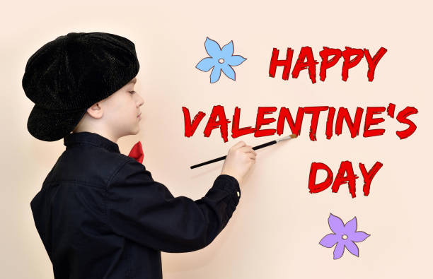 istock Young painter with the brush writing HAPPY VALENTINE’S DAY message on the wall 1197876573