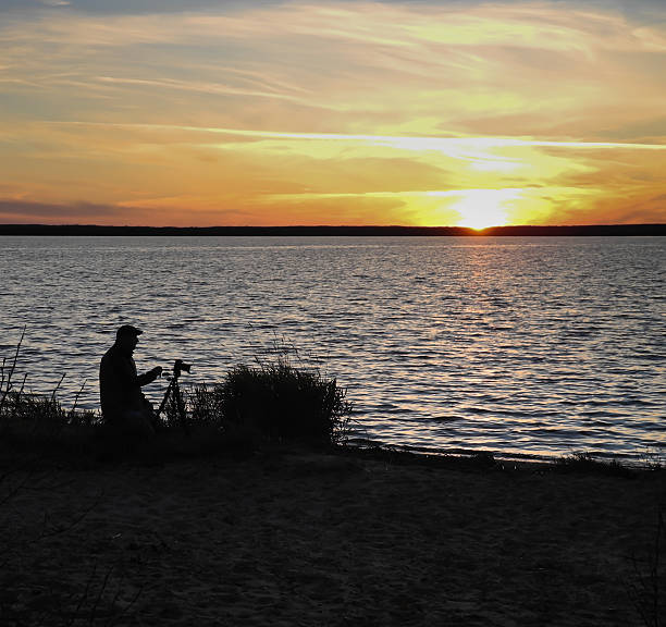 Silhouette of a photographer and his model on a sunset photo shooting
