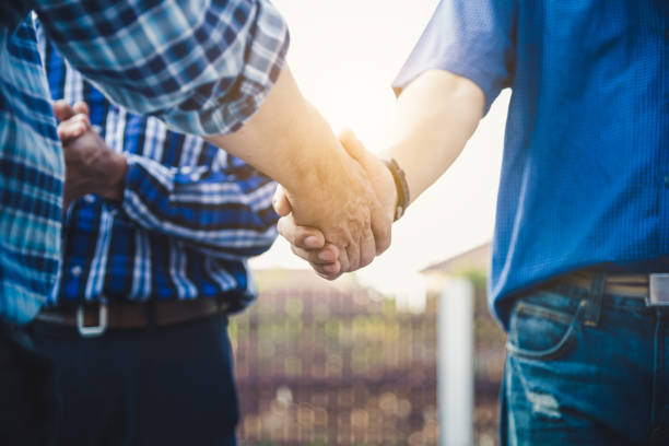 istock Engineers shaking hands at construction site house building for happy living. 1197883457