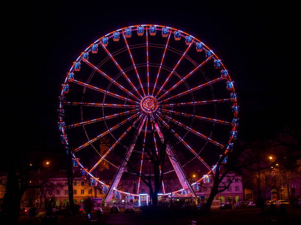 istock Red tone illuminated colorful illuminated ferris wheel at night 1197884586
