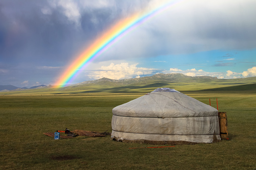 Rainbow over a ger or yurt in the South Gobi Steppe, Mongolia. Traditional national folk mongolian tent house (home) and ethnic architecture.